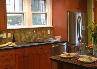 Modern kitchen with wooden cabinets, stainless steel appliances, and a tiled backsplash.